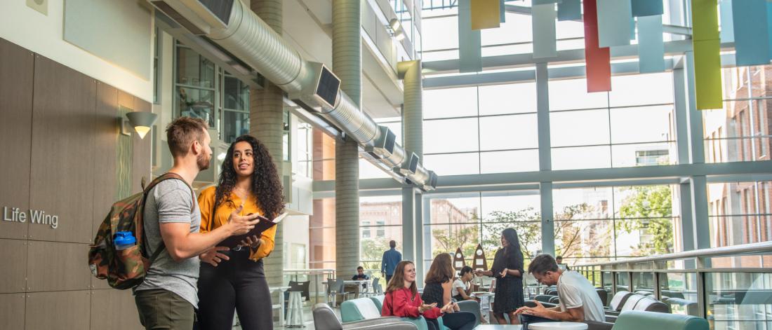 Students inside the University of Manitoba Bannatyne campus Buhler Atrium.