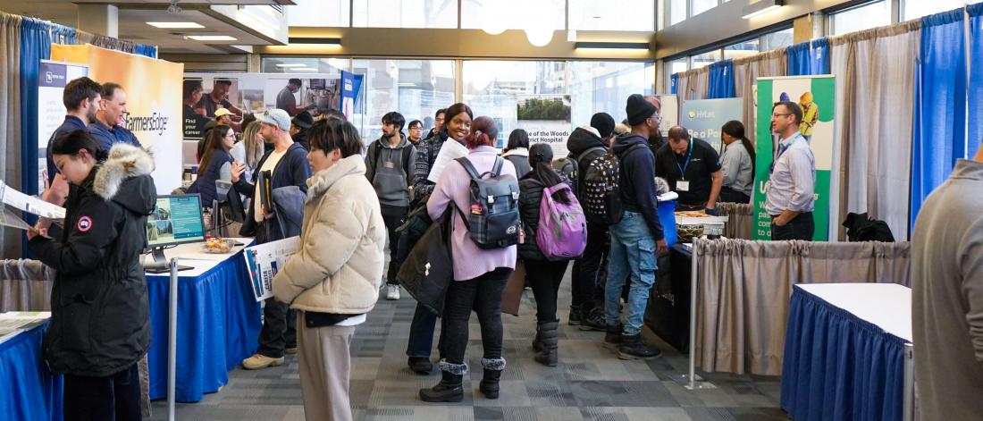Students visit prospective employers at tables at the Career Fair.