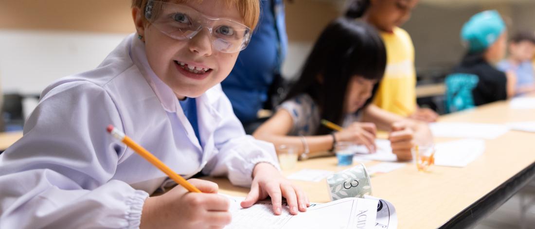 child in lab coat and goggles 