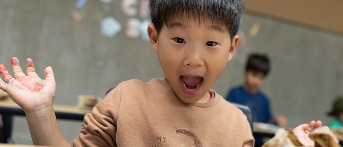 A child look excited at summer camp.