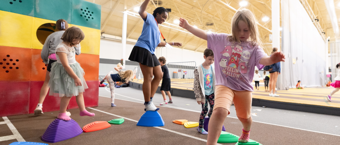 A Mini U camper balancing on blocks during an activity