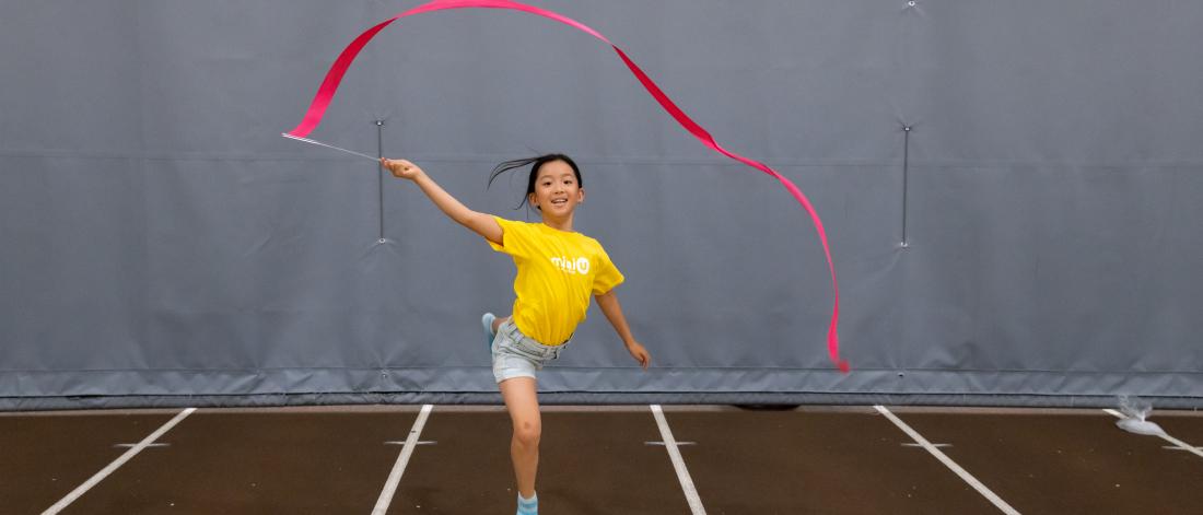 child jumping with ribbon