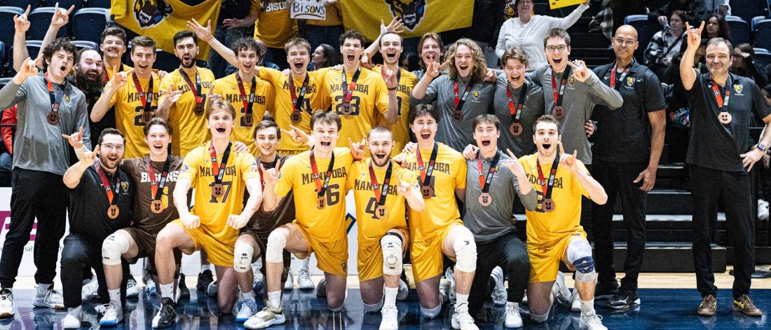 The men's volleyball team pose with their national bronze medals.