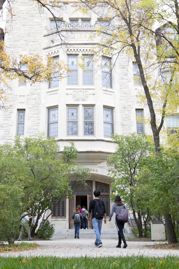 Students walk into the Tier Building on campus.