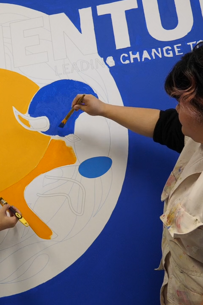School of Art student paints a mural to bring to life UM's new strategic plan.