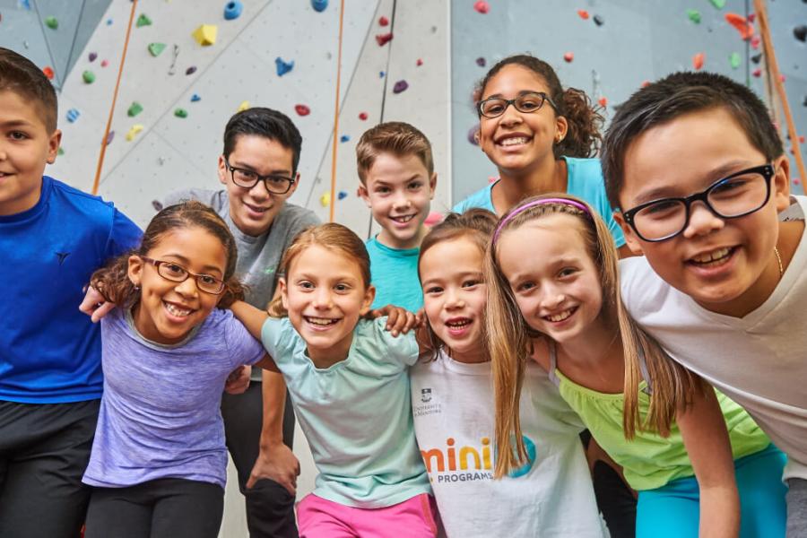 University of Manitoba MiniU students in front of climbing wall.