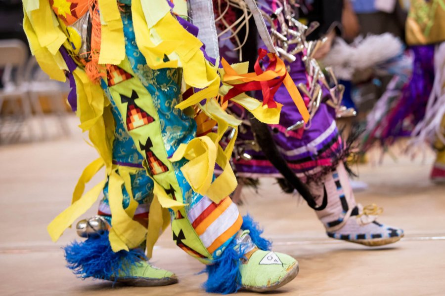 Pow Wow dancers' feet in colourful regalia during Traditional Graduation Pow Wow.