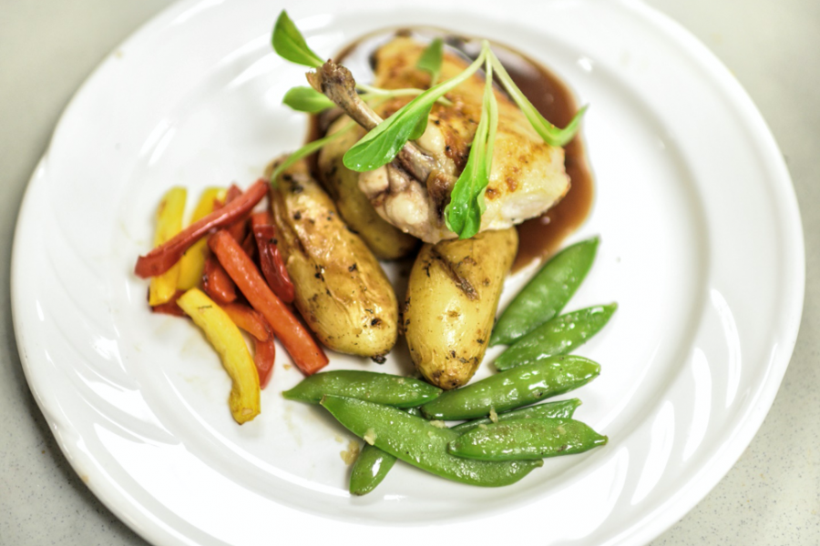 Elegant plated dinner of chicken, potatoes, and vegetables