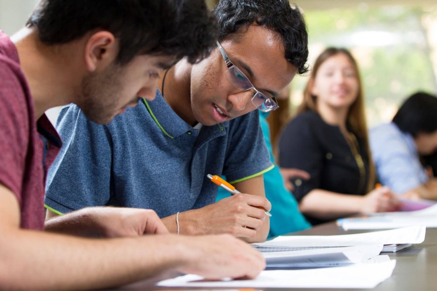 Two students work together at a desk during an Academic Success Workshop.