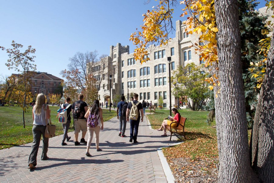 Students walk along a pathway in front of the University of Manitoba Buller Science building.