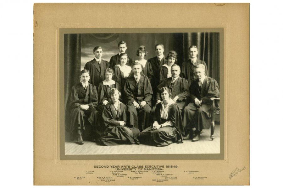 A photograph of the University of Manitoba Second Year Arts Class Executive for the 1918 to 1919 school year, showing 14 people. Labels on matting read: "Second Year Arts Class Executive 1918-19, University of Manitoba. L. Shere, Athletics; J. G. Fletcher, Manitoban; Miss A. Robertson, Year Book; F. W. Newman, Arts Cabinet; H. A. Robertson, Literary; Miss M. Norton, Athletics; Miss F. A. Enright, Literary; H. Ed. Alton, Social; Miss H. F. Bryce, Vice President; H. K. Johnston, President; Prof. W. Tier, Hon.