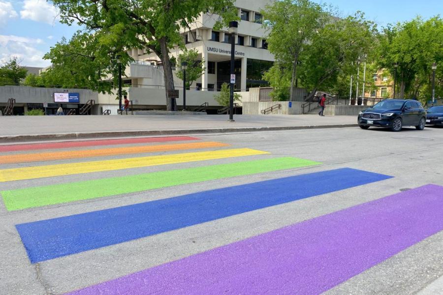 Rainbow rectangles on the street create a colourful crosswalk on the pavement between UMSU University Centre and the Administration Building.