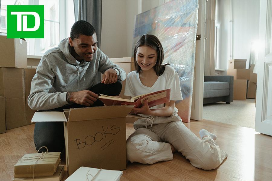 Two homeowners read a book to their child