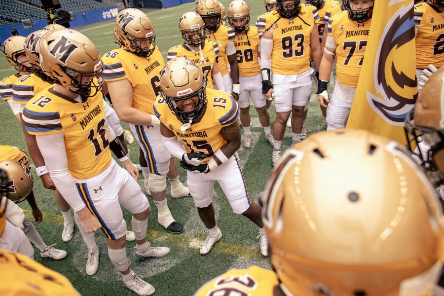 The Bisons football players during a huddle