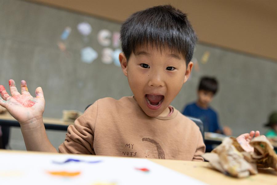 A child look excited at summer camp.