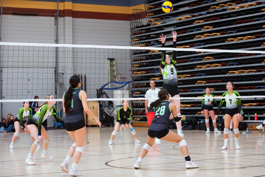 A player jumps to block a ball at the Central Showdown volleyball tournament March 2026.
