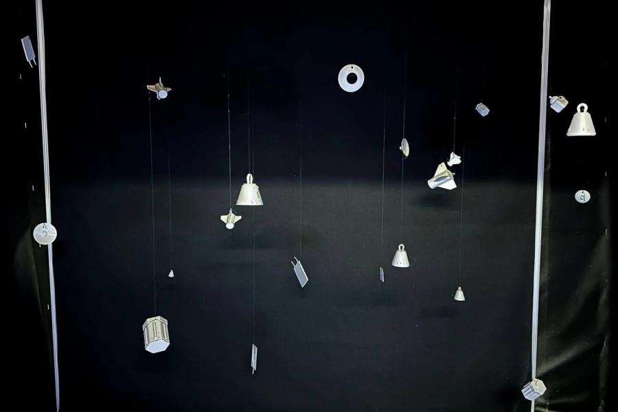 art display of space debris in black space background