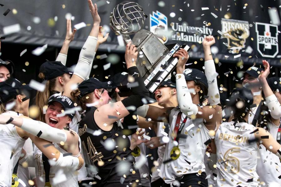 women's volleyball team celebrate with trophy