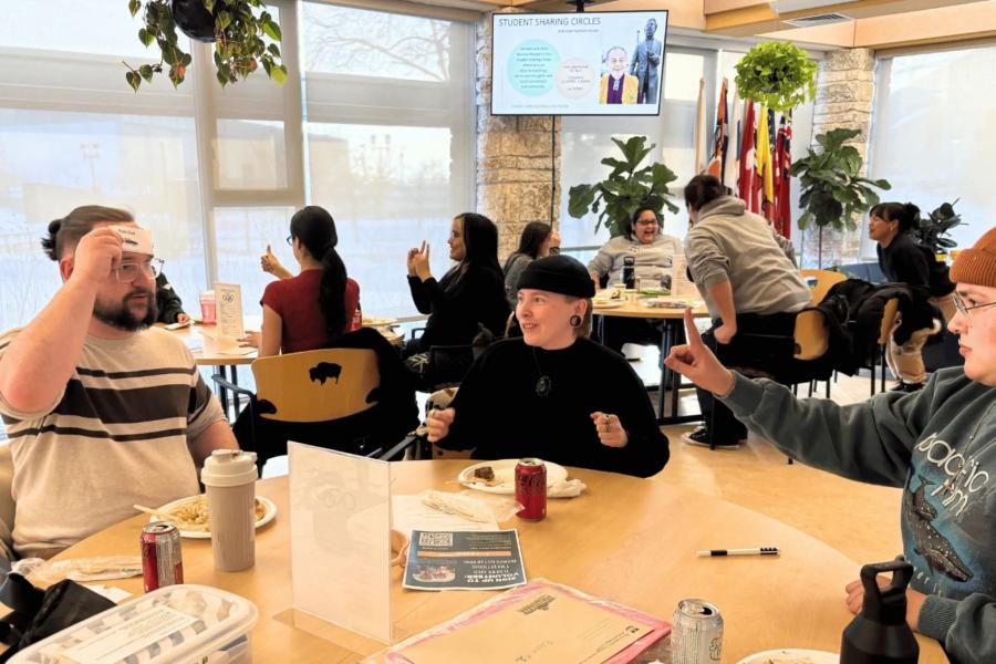 students around a table playing a community building game