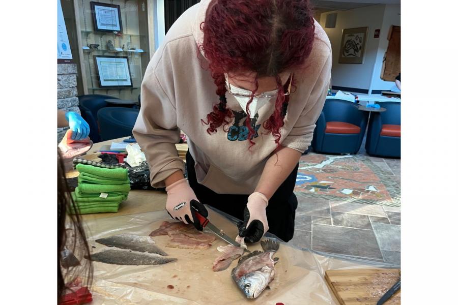 Land and Water participant filleting a fish.