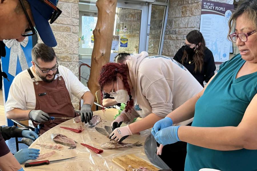 Land and Water participants learning to de-bone fish.