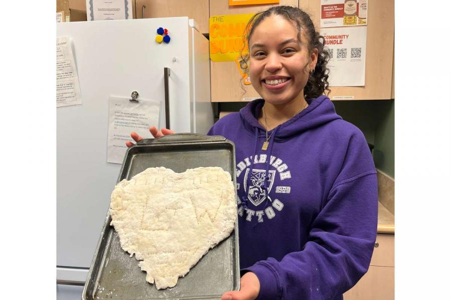 Land and Water participant showing hand made bannock that the group made together.