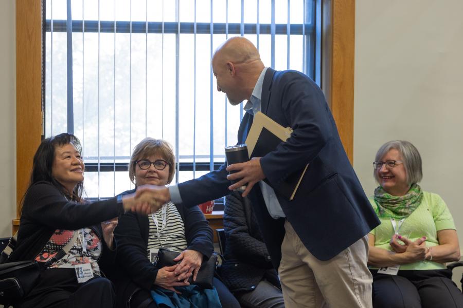Dean Nazik shaking hands with Human Ecology Class of 1976 classmate
