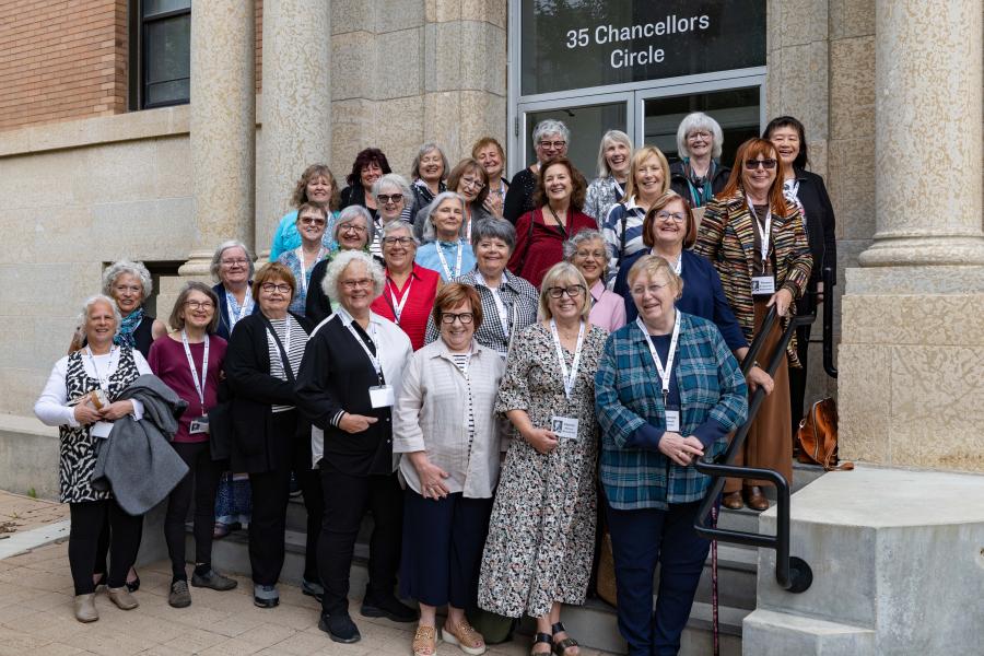 Human Ecology Class of 1976 classmates gathered on the steps of the Human Ecology Building for their 50th reunion group photo