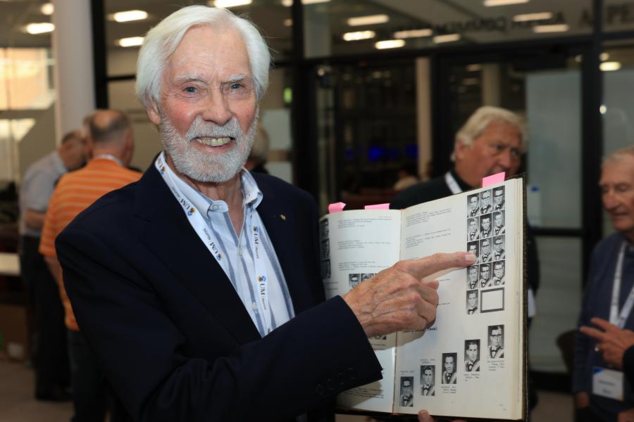 Bob Tollefson pointing at his yearbook photo