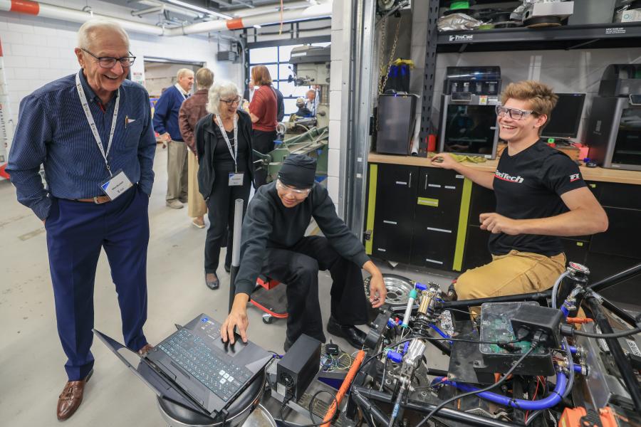 Civil Engineering Class of '66 60th reunion member interacting with students in garage
