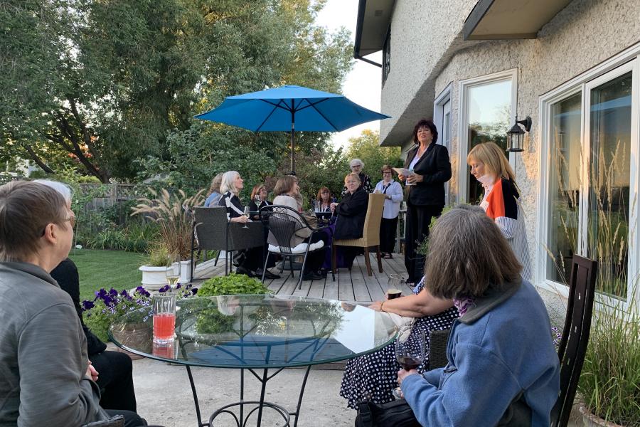 Avis Gray delivering greetings at backyard welcome reception