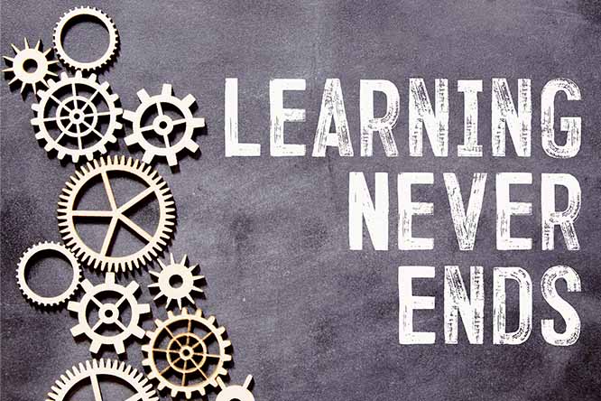 A chalkboard with gears and the wording "learning never ends" on the right.