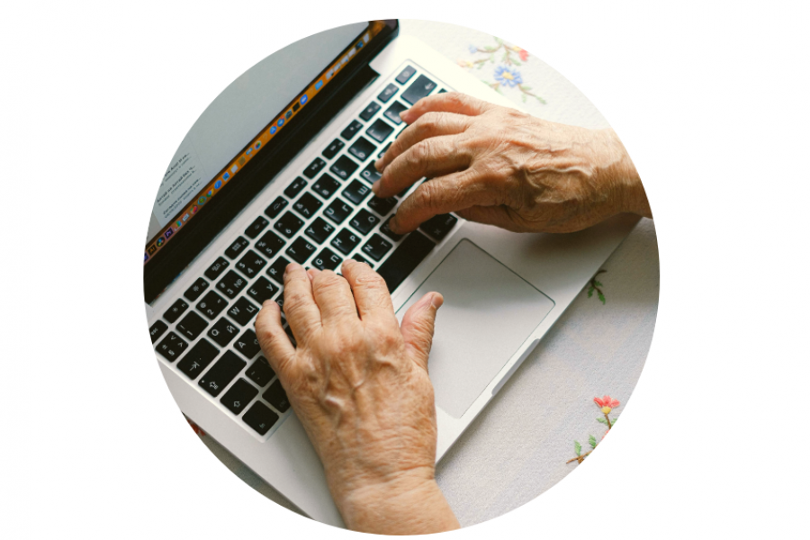 Hands typing on a laptop