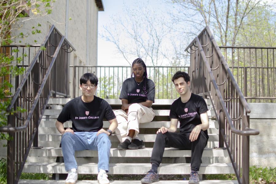 Dons of St John's Residence sitting on stairs