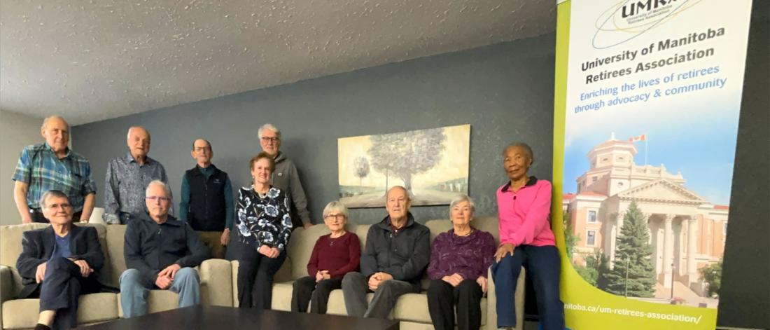 executive committee members seated and standing by sofa